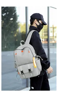 Close-up of lightweight grey water-resistant backpack with orange zipper accents