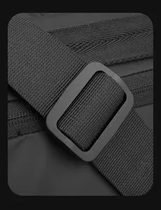Detail of durable nylon strap and matte buckle on a waterproof black messenger bag