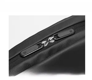Close-up of durable black nylon crossbody bag featuring smooth dual zipper closure detail