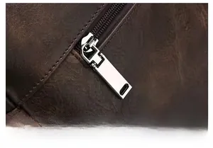 Detail of premium dark brown leather texture and smooth silver metal zipper on briefcase