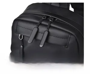 Macro detail of smooth dual zippers on black waterproof chest bag with matte hardware