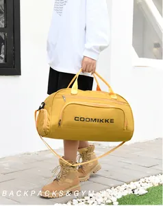Outdoor shot of a mustard yellow fitness bag featuring a side pocket and adjustable strap