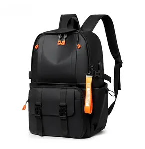 Detail view of large capacity black backpack with USB port and orange zipper accents