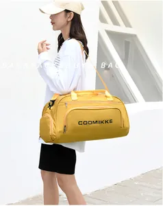 Outdoor model shot of bright yellow large capacity travel gym bag with shoulder strap