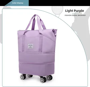 Detail view of a light purple waterproof travel bag with rolling wheels and sturdy handles