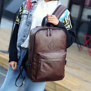 Men's dark brown PU leather backpack with vintage matte finish and front zipper pocket