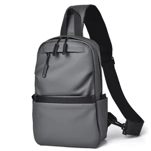 Waterproof men's sling bag in dark grey with a minimalist multi-pocket design for travel