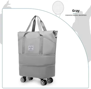 Detail view of the grey travel bag showing reinforced handles and smooth rolling wheels