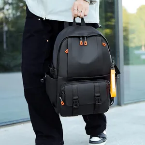 Large capacity black waterproof backpack with orange accents for travel and school