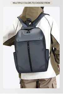Detail of dark grey waterproof commuter backpack worn by model in a studio setting