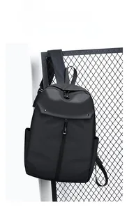 Detail view of black waterproof matte commuter backpack with vertical zipper on metal grid