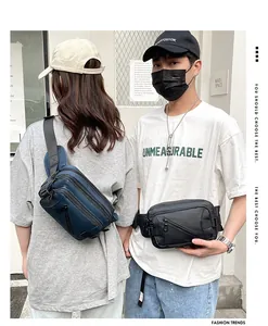 Street style shot of black and navy oxford fabric waist bags with multiple compartments