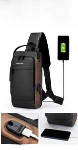 Detail of men's sling bag showing built-in USB charging port with connected phone