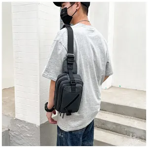 Detail of street style crossbody bag with multiple zip compartments and durable wide strap