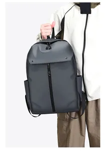 Detail of dark grey waterproof backpack featuring top flap buckle and vertical front zipper