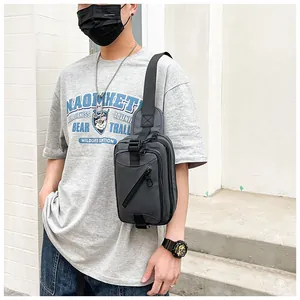 Detail of dark gray men chest bag with water-resistant fabric and zipper pocket