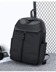 Close-up of a matte black waterproof backpack with hidden vertical zipper and side pockets