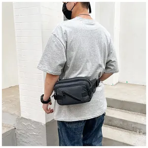 Detail of dark grey waterproof nylon waist bag with adjustable straps and zipper pockets