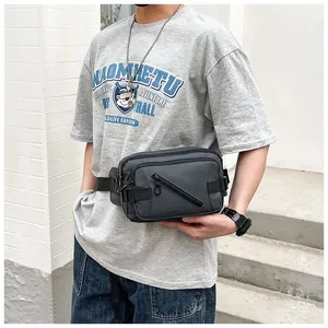 Detail of dark gray outdoor waist bag featuring functional multi-zippered compartments