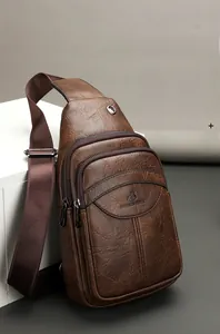 Detail of vintage brown textured leather chest bag with zipper and logo brand