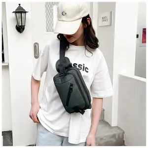 Dark tactical crossbody bag styled on white T-shirt for a modern street look