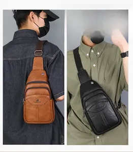 Detail of multi-compartment leather chest bag with adjustable strap and earphone port