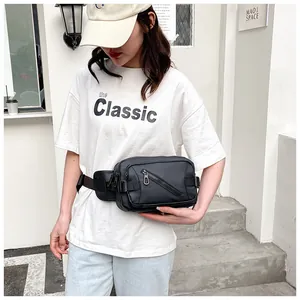Close-up of black nylon waist bag with adjustable straps and durable plastic buckle detail