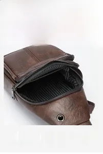 Detail of vintage brown leather chest bag showing multi-layer compartments and lining