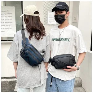 Outdoor street shot of multi-functional navy and black nylon cross-body waist bags
