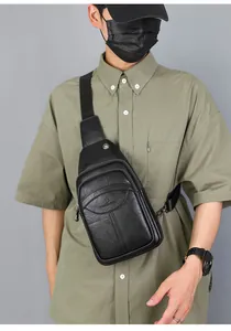 Detailed close-up showing the pebbled faux leather texture and embossed logo on black chest bag