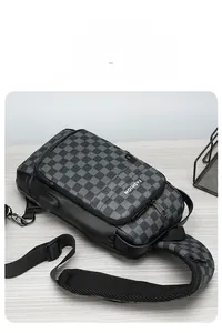 Detail of checkered anti-theft chest bag with USB charging port on a wooden desk