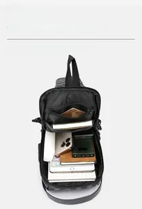 Macro view showing large capacity main compartment of grey checkered men's chest bag