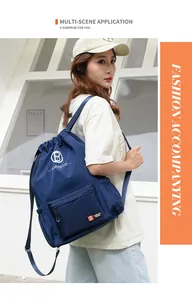 Detail view of the blue water-resistant nylon drawstring backpack with zipper pocket