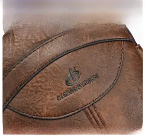 Close-up of vintage brown leather bag featuring an embossed brand logo and stitch details