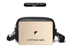 Size comparison between the black patterned crossbody bag and a 7.9-inch iPad Mini