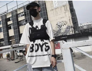 Primer plano de la bolsa táctica de pecho negra con bolsillos sobre camiseta blanca