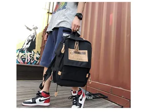 Detailed view of canvas backpack featuring designer label on urban graffiti background