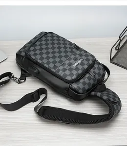 Detail shot of men's checkerboard sling bag showing USB charging port and zipper pocket
