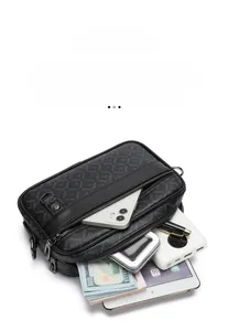 Detailed view of black monogram crossbody bag compartments showing storage capacity