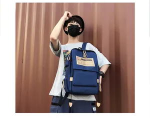 Detail of navy canvas backpack showing vintage label and high-quality leather pull tabs