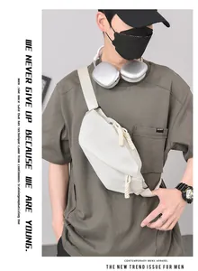 Detail view of a white casual sling bag for men worn as a crossbody chest pack