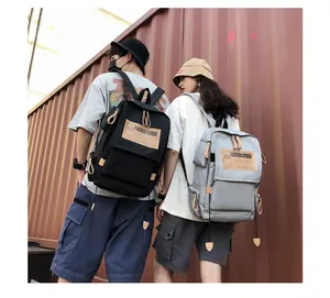Outdoor view of multi-pocket canvas backpacks in black and grey for travel and students
