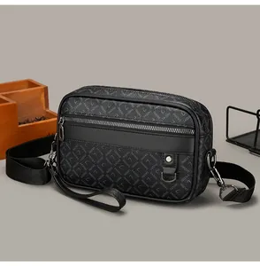 Detail view of the black crossbody bag showing textured leather and brand lettering