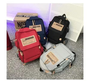 Canvas backpack selection in red, navy, black and grey with vintage design patch
