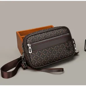 Detail of brown crossbody bag with SADINI monogram print and double zipper closure