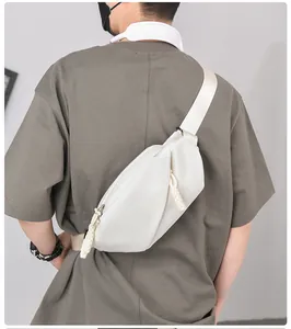 Detail of white nylon crossbody bag showing soft texture and adjustable woven strap