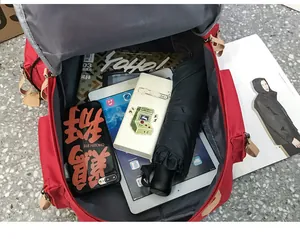 Spacious interior of red canvas backpack showing compartments for tablets and daily items