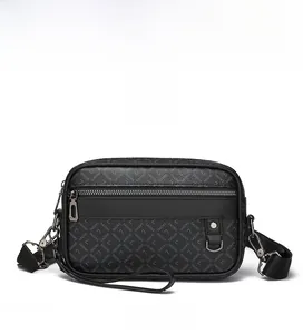Detail of black crossbody bag with embossed texture, front zipper pocket and metal ring