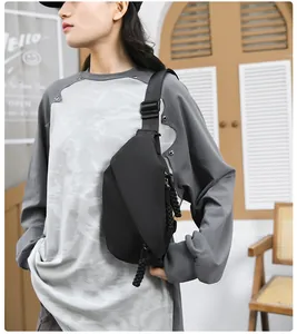 Detailed view of black nylon crossbody chest bag with adjustable strap and zip detail