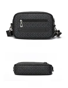 Detail of black monogram crossbody bag showing back zipper pocket and luggage strap